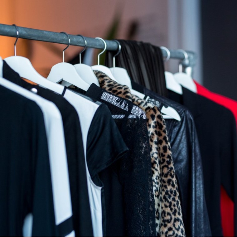 Portant de vêtements noirs et blancs sur cintres